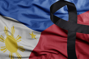 waving national flag of philippines with black mourning ribbon .tragedy concept