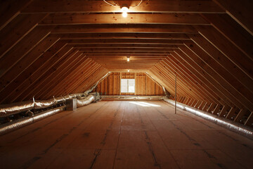 Empty Attic Space With Exposed Wooden Beams And Light