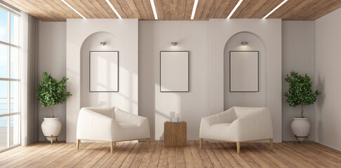 Modern living room with two armchairs and blank frames showing modern interior design