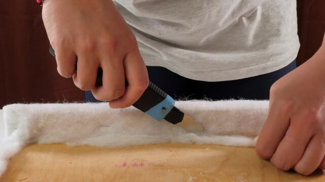 fixating fleece layer on chair seat with staple gun detail