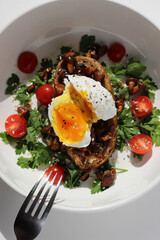 Eating Breakfast. Cut Poached Egg, Fried Chanterelles on Rye Bread Toast. 