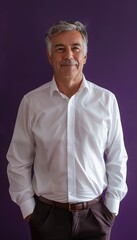 Obraz premium Confident Mature Man in White Dress Shirt Against Deep Purple Background for Professional Use