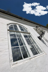 Vintage hotel, building and window in city for holiday, vacation and low angle outdoor. Glass, home exterior and facade of old architecture for design, construction or real estate property with plant