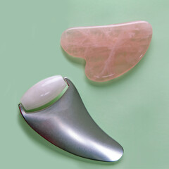 Niphrite massagers for skin rejuvenation on a mint-coloured background