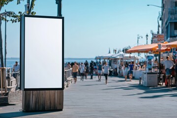 Blank billboard on bustling boardwalk by the sea on a sunny day