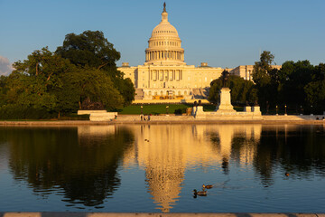 United States Capitol reflected on the water at sunset