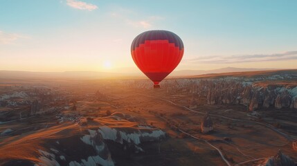 Obraz premium Gorgeous sunrise view of the rocky Cappadocia countryside, complete with vibrant hot air balloon rides over the deep valleys and gorges. Travel with a concept banner in Turkey. 