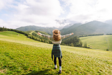 Happy Woman tourist admiring the landscape mountains nature. Beautiful mountains landscape.