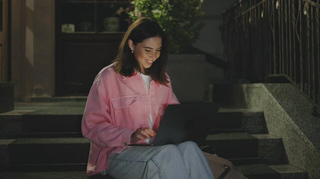 A young woman enjoys a beautiful night under the stars with her laptop, embracing a cozy lifestyle filled with innovation, inspiration, and exciting freelance opportunities