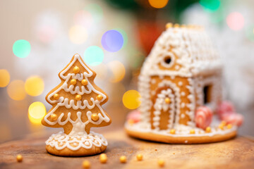 Gingerbread house made of gingerbread cookies decorated with icing, caramel, candy, decorative...