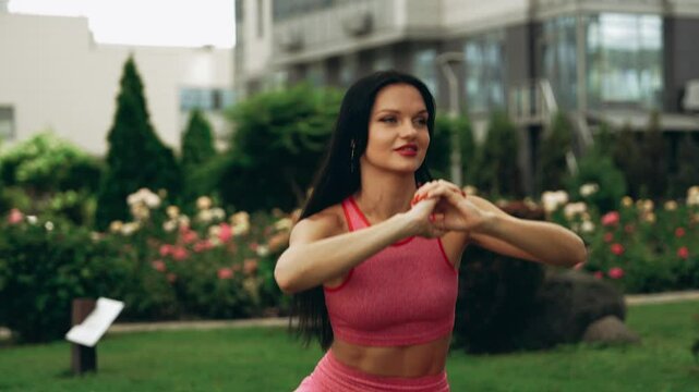 Fitness enthusiast demonstrates outdoor workout routine in a garden setting