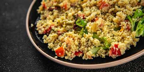 Tabbouleh bulgur couscous vegetables dish fresh vegetarian and vegan food gourmet food background on the table rustic food top view 