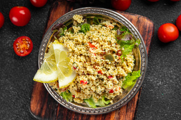 Tabbouleh bulgur couscous vegetables dish fresh vegetarian and vegan food gourmet food background on the table rustic food top view 
