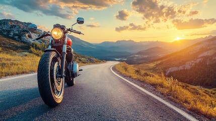 Motorcycle parked on a winding road at sunset