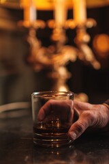 Hand Holding a Whiskey Glass with Ice