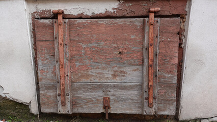 Rustic Wooden Cellar Door With Rusty Hinges in Countryside Building