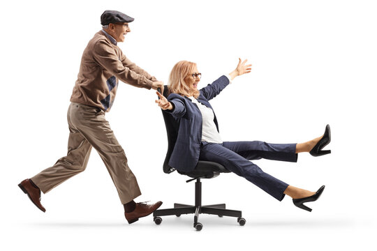 Elderly man pushing a businesswoman seated in an office chair - Powered by Adobe