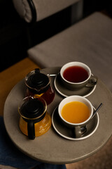 Relaxing afternoon with a stylish tray of herbal tea, vibrant orange juice, and rich coffee served in a cozy café