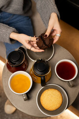 Enjoying a cozy afternoon with tea, coffee, and freshly baked treats in a warm café setting