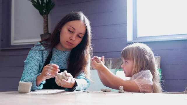 A creative clay modeling session with a child at home in the afternoon