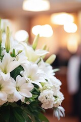 White lilies in a blurred floral arrangement