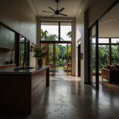 Obraz premium Modern kitchen with large windows overlooking a tropical garden.
