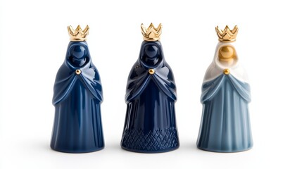 Three Kings figurines made of porcelain, intricately detailed with flowing robes and crowns, isolated on a white background for Reyes Magos decor 
