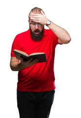 Young hipster man wearing glasses and reading a book over isolated background stressed with hand on...