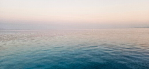 Tranquil seascape with clear blue sky and calm, turquoise water.








