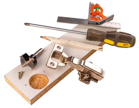 Installing furniture hinges in chipboard. Isolated background.