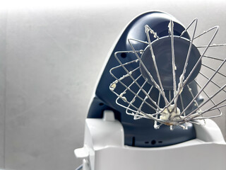 Mixer in the kitchen at home. Equipment for making cream. Professional mixer is on the table. Mixer whips cream. Pastry tools. Making a cake