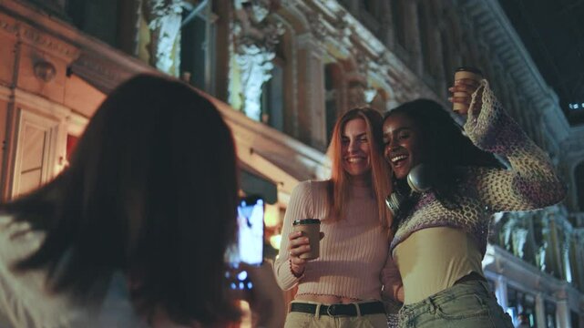 Experience a Joyful Night Out Friends Capturing Unforgettable Memories Against the Backdrop of Stunning City Lights and the Vibrant Energy of Urban Life, Inviting Togetherness and Fun
