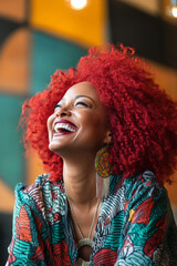 Fototapeta premium A middle-aged Black woman with striking red hair is captured laughing joyfully, her vibrant locks swirling around her in a lively setting. Her laughter is contagious, and her energy radiates in every