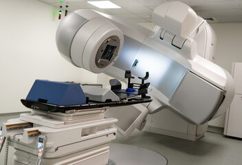 A linear accelerator machine in an empty treatment room, showcasing advanced medical technology used for precise radiotherapy. The clean, modern environment emphasizes innovation in cancer treatment.
