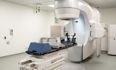 Empty radiotherapy treatment room with linear accelerator ready for use. The clean, modern medical environment showcases advanced cancer treatment technology and precision equipment for patient care