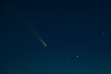 Comet Tsuchinshan-ATLAS shines brightly as it streaks across the night sky with a long glowing...