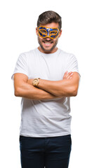 Young handsome man wearing carnival mask over isolated background happy face smiling with crossed arms looking at the camera. Positive person.