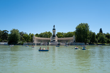 Great Pond of El Retiro with boats and Monument to Alfonso XII in Madrid