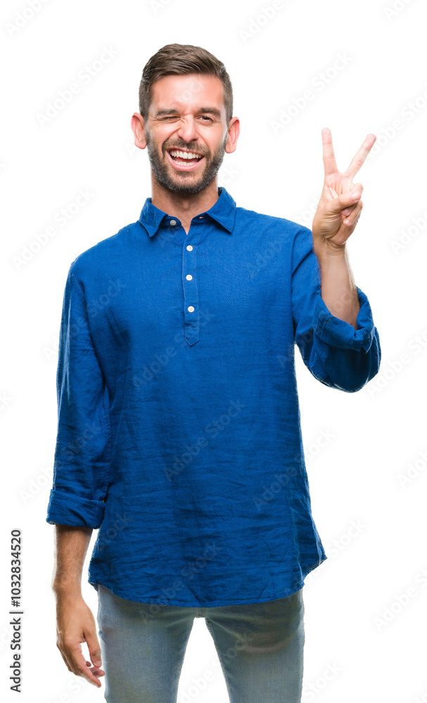 Sticker Young handsome man over isolated background smiling with happy face winking at the camera doing victory sign. Number two.