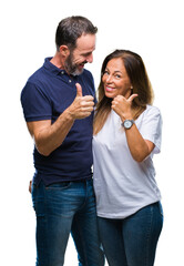 Naklejka premium Middle age hispanic casual couple over isolated background doing happy thumbs up gesture with hand. Approving expression looking at the camera with showing success.