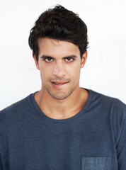 Obraz premium Portrait, proud and man in studio, fashion and serious with outfit, trendy and stylish with clothes. White background, student and model with tshirt, confident and person in college, cool and Cuba