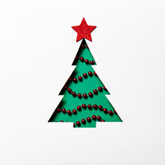 Christmas tree with a red star, white pom-poms, and beads on a white background. Christmas card. Mockup for festive advertising and greetings.