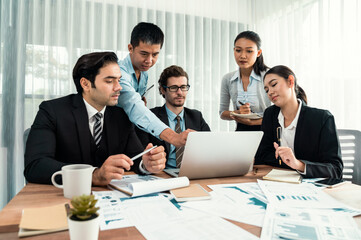 Diverse group of business analyst team analyzing financial data report paper on office table. Chart and graph dashboard by business intelligence analysis for strategic marketing planning Habiliment