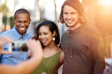 People, friends and city with photography for group picture, camera or memory together on sidewalk. Young, community or team with smile, hug or joy for capture, moment or friendship in an urban town