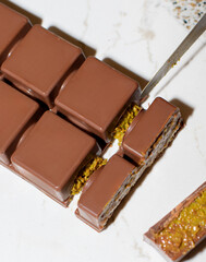 Dubai chocolate, viral chocolate 2024, trends , homemade chocolate with pistachio and kadaif, chocolate in a section