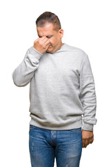 Fototapeta premium Middle age arab man wearing sport sweatshirt over isolated background tired rubbing nose and eyes feeling fatigue and headache. Stress and frustration concept.