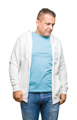 Middle age arab man wearing sweatshirt over isolated background looking away to side with smile on face, natural expression. Laughing confident.
