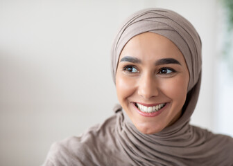 Closeup portrait of cheerful muslim lady in stylish headscarf looking at copy space, panorama....