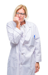 Middle age blonde therapist woman wearing white coat over isolated background looking stressed and nervous with hands on mouth biting nails. Anxiety problem.