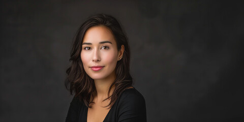 Fototapeta premium Elegant Portrait of a Young Woman with Natural Beauty Against a Dark Background